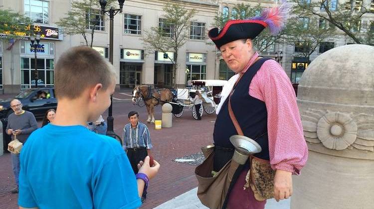 Magician Taylor Martin entertains a crowd on Monument Circle. - Christopher Ayers/WFYI