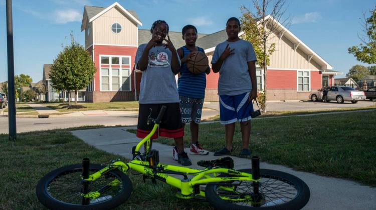 Mario (R) and his friends take a break from playing to pose for photographer Aaron Pierce. - Photo By: Aaron Pierce