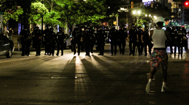 Holcomb Relies On Local Leaders To Request State Police, National Guard Support -  Police march on the gathering at Delaware and Market streets in downtown Indianapolis, blocking traffic. Shortly after, they deployed tear gas, flares and pepper spray pellets at protesters. (Lauren Chapman/IPB News)