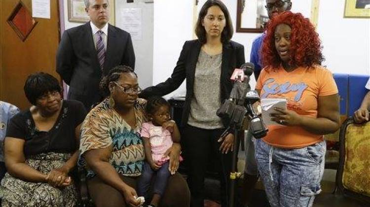 Rachel Long, fiancee of Donte Sowell, reads a statement as the filing of a federal lawsuit alleging excessive force in Sowell's death is announced in Indianapolis, Thursday, Sept. 10, 2015. The lawsuit filed Thursday on behalf of 27-year-old Donte Sowellâ€™s estate names the city of Indianapolis and several other defendants. Police have said an officer and a security guard opened fire on Sowell after he fled the traffic stop and began shooting at a pursuing officer. - The Associated Press