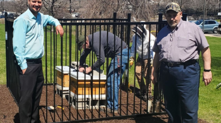 Property Manager Josh Westhouse and Supervisory Property Manager Rich Falzone stand outside the new bee hive enclosure as workers complete installation at the U.S. Courthouse in Hammond.  - U.S. General Services Administration