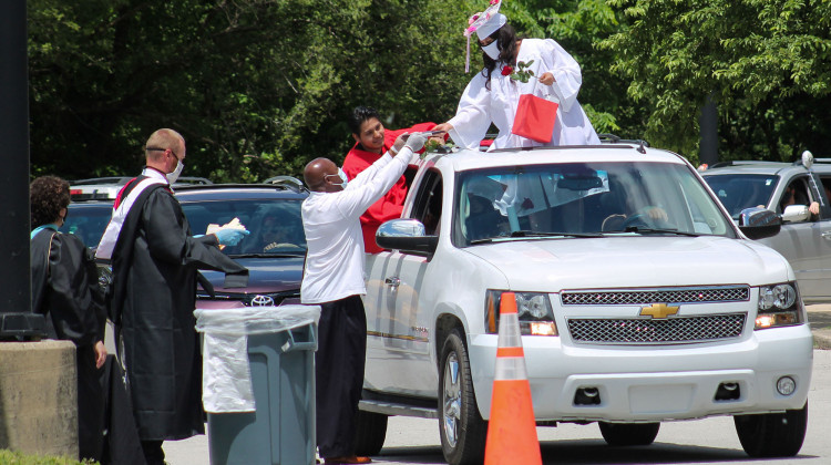 Graduating students and staff wear protective masks during the ceremony. Teachers from Emmerich Manuel High School handed out diplomas and gifts during the drive-thru ceremony on May 30. - Lauren Chapman/IPB News