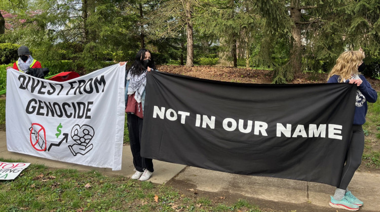 Pro-Palestinian protesters stand outside Gov. Eric Holcomb's residence in mid-town Indianapolis on Thursday, April 25, 2024.  - Jill Sheridian / WFYI