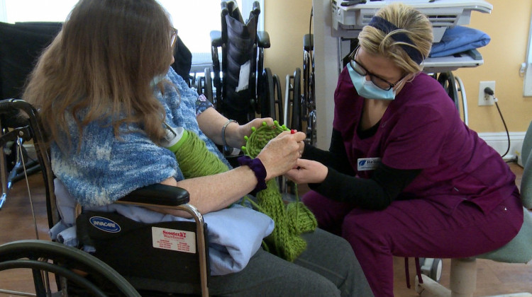 A worker at a South Bend nursing home helps a patient with a physical therapy exercise. - (Justin Hicks/IPB News)