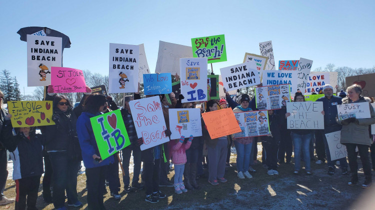 Attendees at Saturday's rally hold signs in support of saving Indiana Beach. - Samantha Horton/IPB News
