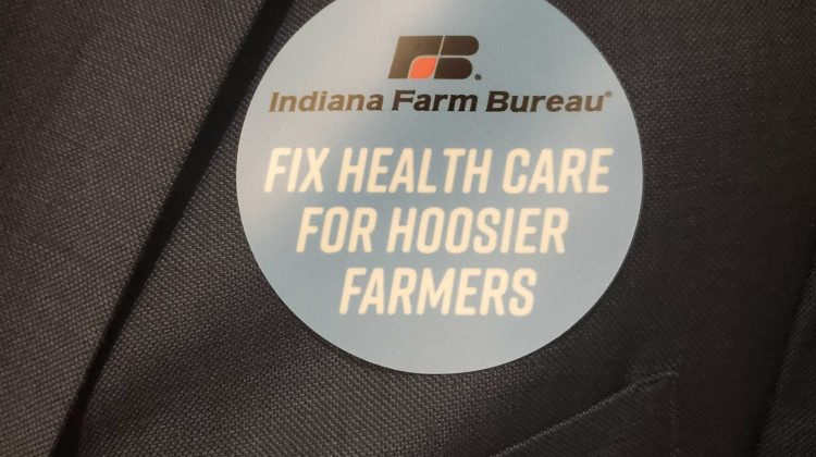 Indiana Farm Bureau members wear stickers to show support for a bill that would allow the organization to offer health benefit plan. - Samantha Horton/IPB News