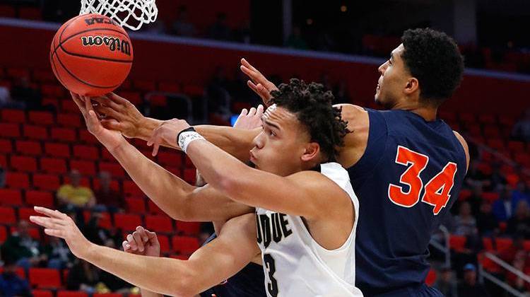 Purdue guard Carsen Edwards (3) and Cal State Fullerton forward Jackson Rowe (34) battle for a rebound during the first half of an NCAA men's college basketball tournament first-round game in Detroit, Friday, March 16, 2018. - AP Photo/Paul Sancya