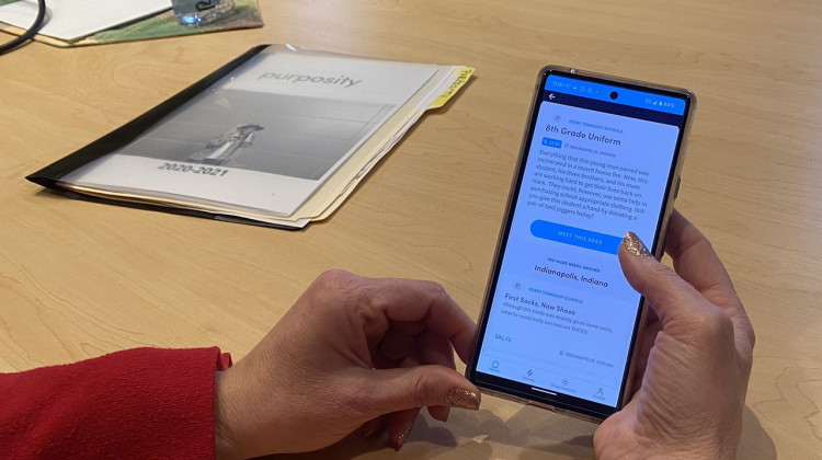 Stephanie Quinlan, Perry Township Schools’ Assistant Director of Students, demonstrates Purposity. The app allows community members to purchase basic items needed by students anonymously. - (Elizabeth Gabriel/WFYI)