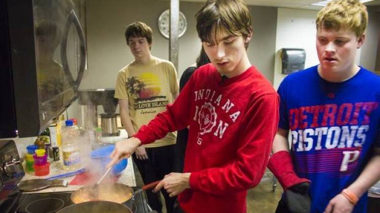 Reagan Roush, center, makes a creamy chicken fajita pasta dish at a weekly cooking skills class at the College Internship Program in Bloomington, Indiana.  - Peter Balonon-Rosen/IPB