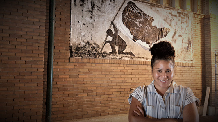 Artist Rebecca Robinson stands in front of her work on the Meridian Street side of Union Station. - Courtesy Rebecca Robinson