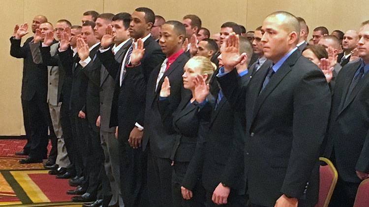 IMPD recruits being sworn in at December 2015 ceremony. New recruits hit the streets next month. - Deron Molen/WFYI