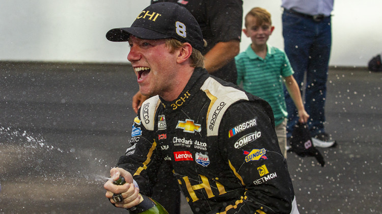 Tyler Reddick celebrates by spraying champagne after winning on the road course at Indianapolis Motor Speedway. - Doug Jaggers/WFYI