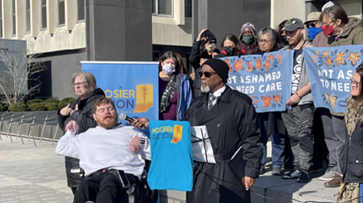 Lucas Waterfill speaks in front of the City-County Council Building in downtown Indianapolis, demanding the Health and Hospital Corporation Board rescind their Supreme Court petition, on Nov. 14. - Sydney Dauphinais/WFYI
