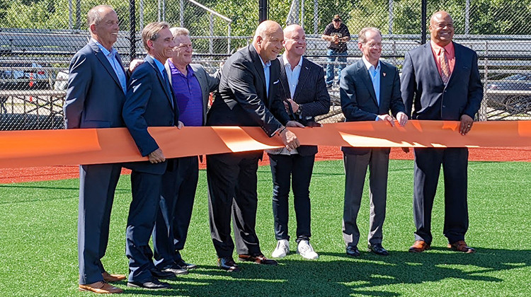 Cal Ripken, Jr. (center, leaning forward) helps officials from Muncie, Ball State University, and the Cal Ripken, Sr. Foundation dedicate Gainbridge Field. - Stephanie Wiechmann/IPR News