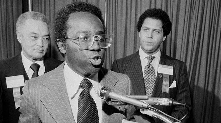 Mayor Richard Hatcher of Gary, Ind., center, reads a telegram to the United States Senate that he and seven other mayors sent regarding a proposal to lift sanctions against Zimbabwe-Rhodesia during the 1979 U.S. Conference of Mayors. - AP Photo