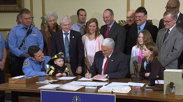 Gov. Mike Pence signs the "Right to Try" legislation into law. - Gretchen Frazee