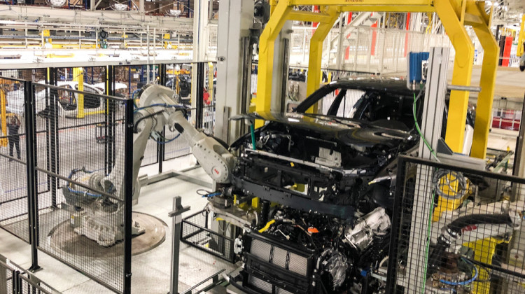 A robotic arm works on the production line at Volvo's factory in Ridgeville, S.C. But other essential jobs, including major portions of final assembly, are still left to people. - Camila Domonoske/NPR
