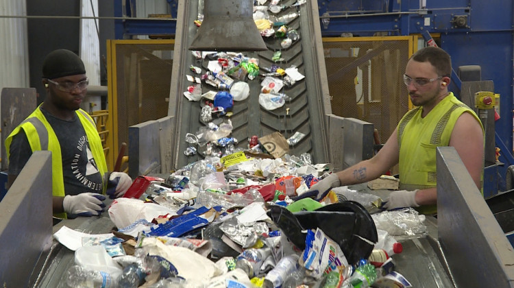 Workers sort recycling at Rumpke's material recovery facility in Cincinnati, Ohio. - Zach Herndon/WFIU