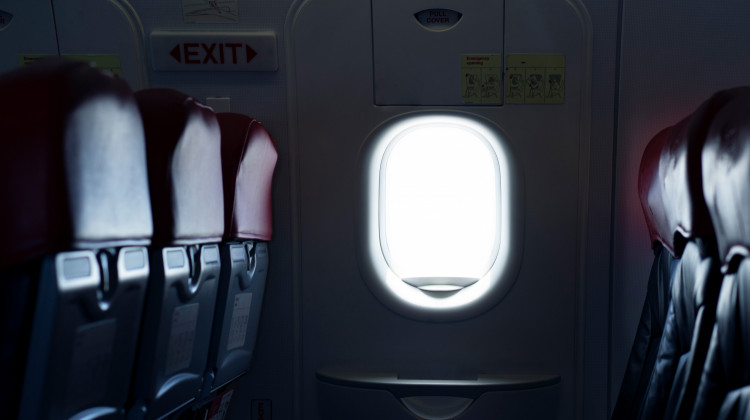 Where should you sit on a plane to reduce the risk of exposure to germs spread by infectious passengers? - skaman306/Getty Images