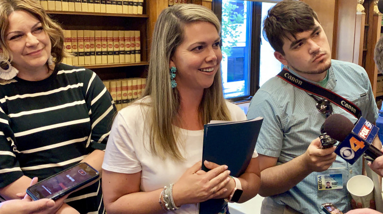 Indiana Gaming Commission Executive Director Sara Tait, center, speaks with reporters after the commission approved sports wagering rules. - Brandon Smith/IPB News