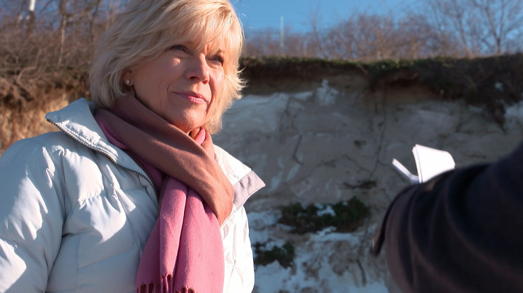 Chicago native Nancy Schwab stands in front of a large scour that is threatening her vacation home in Beverly Shores, Indiana.  - Alan Mbathi/IPB News