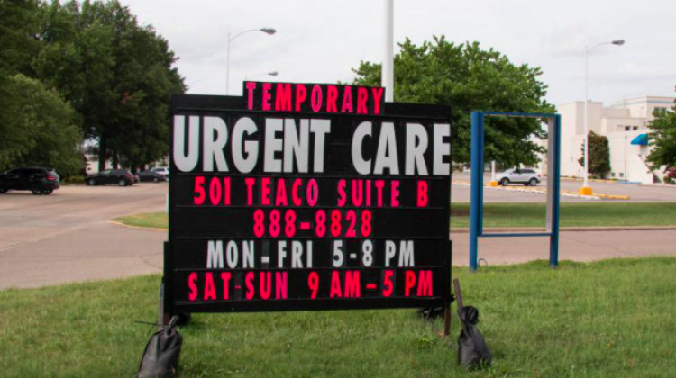 In 2018, a sign behind a closed hospital in Kennett, Missouri advertised a new urgent care center in 2018. - PHOTO BY: BRAM SABLE-SMITH