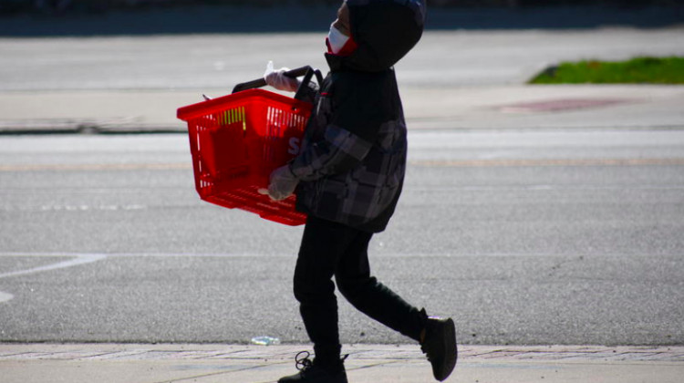 A child carries a basket of groceries in Gary, Indiana. - Justin Hicks/IPB News