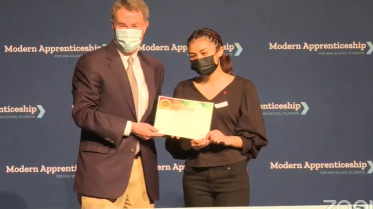 Indianapolis Mayor Joe Hogsett poses for a photo with Ben Davis High School student Ruby Galvan. Galvan will be an apprentice with the city government. - Justin Hicks Screenshot EmployIndy Facebook Live