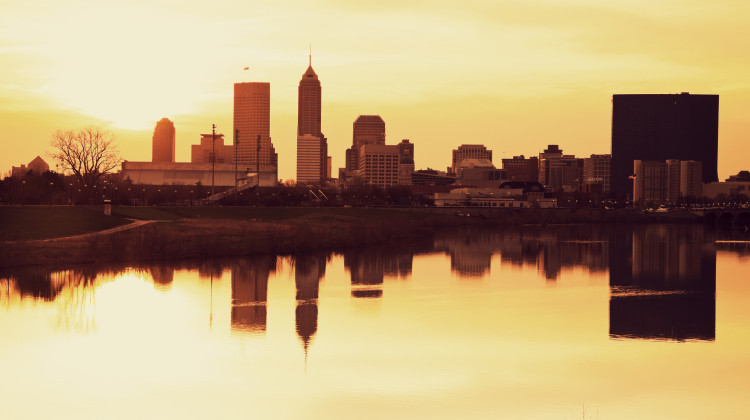 The Indianapolis skyline is reflected in the White River. - Stock photo