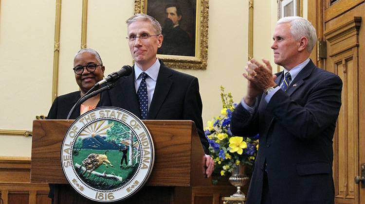 Geoffrey Slaughter at the podium, joined by his wife Julie and Gov. Mike Pence. - Drew Daudelin