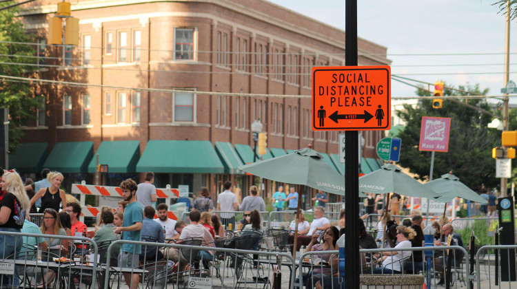 Indianapolis shut down several streets to allow restaurants to expand outdoor seating. Along these streets signs remind people to maintain six feet of distance.  - Lauren Chapman/IPB News