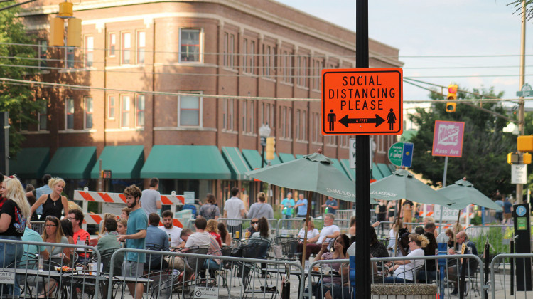 Indianapolis shut down several streets to allow restaurants to expand outdoor seating. Along these streets signs remind people to maintain six feet of distance. - Lauren Chapman/IPB News
