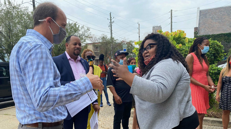 Ashley Thomas, regional organizing director for Stand for Children Indiana, talks to IPS Board of Commisioner members Will Pritchard (left) and Kenneth Allen outside the district office on Thursday, July 29, 2021. - (Elizabeth Gabriel/WFYI)