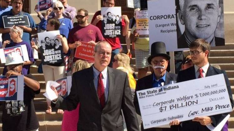 IU Law Professor Fran Quigley and protestors from the Raise the Wage Indiana Coalition gather on the Statehouse steps asking Governor Mike Pence  to raise the minimum wage by executive order.  - Payne Horning