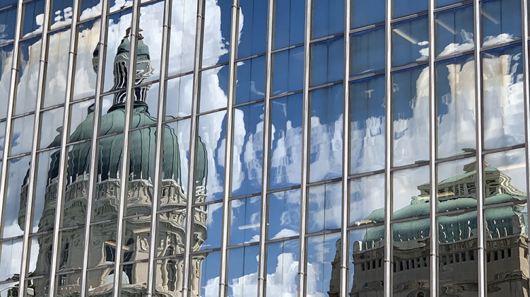 The Indiana Statehouse reflected in the windows of a nearby building. - Doug Jaggers/WFYI