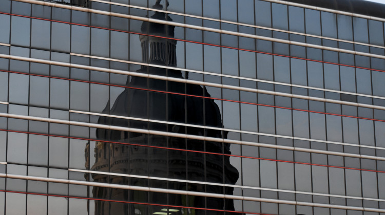 The Indiana Statehouse reflected in the windows of a nearby building. - Justin Hicks/IPB News