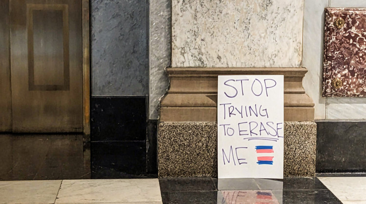 At the end of the ACLU's Rally To Protect Trans Youth on Saturday, April 1, a protester left a sign reading "Stop trying to erase me" with a transgender pride flag next to the elevators inside the Indiana Statehouse.  - Lauren Chapman/IPB News