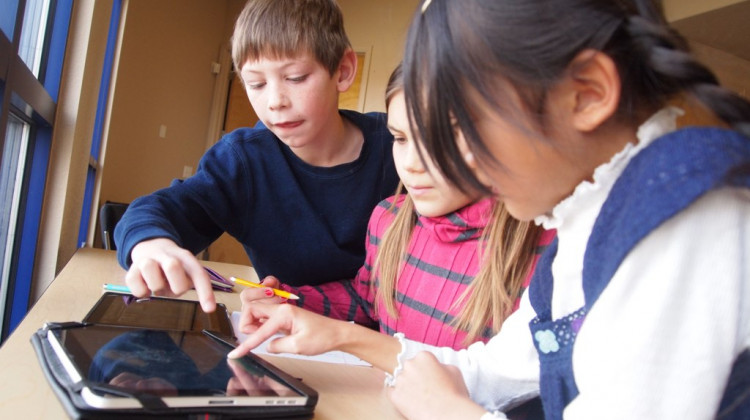 Students work on an internet connected device.  - Flickr