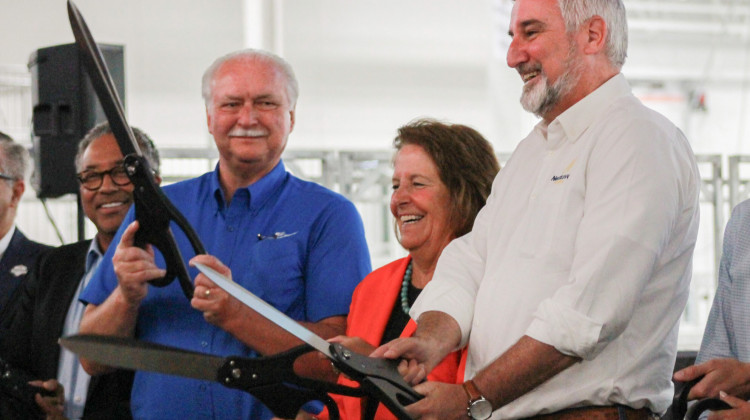 From left, Indiana Farm Bureau President Randy Kron, State Fair Executive Director Cindy Hoye and Gov. Eric Holcomb ceremonially cut the ribbon at the Indiana Farm Bureau Fall Creek Pavilion on Thursday, July 20, 2023.  - Brandon Smith/IPB News