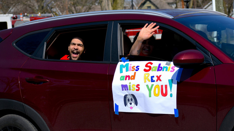 outh Bend Community School's Madison STEAM Academy teachers drive through neighborhoods to waive to their students after the state announced school buildings would be closed for the academic year. - Justin Hicks/IPB News