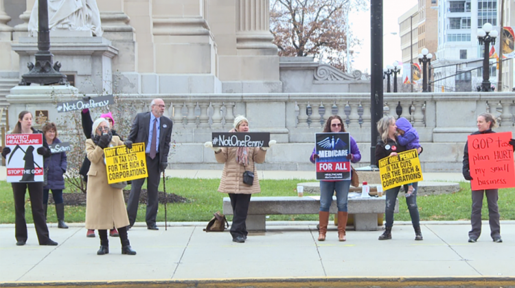 Demonstrators hold signs and chant outside the federal courthouse in Indianapolis. - Ryan Flanery/WFYI News