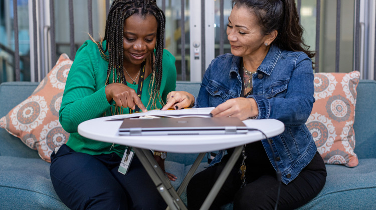 Serena Maria, manager of care teams at Homebridge, Inc., talks with Care Supervisor Camille Mbotchawo at Homebridge headquarters on Friday, Oct. 14, 2022, in San Francisco, California. - Constanza Hevia H. / For Tradeoffs