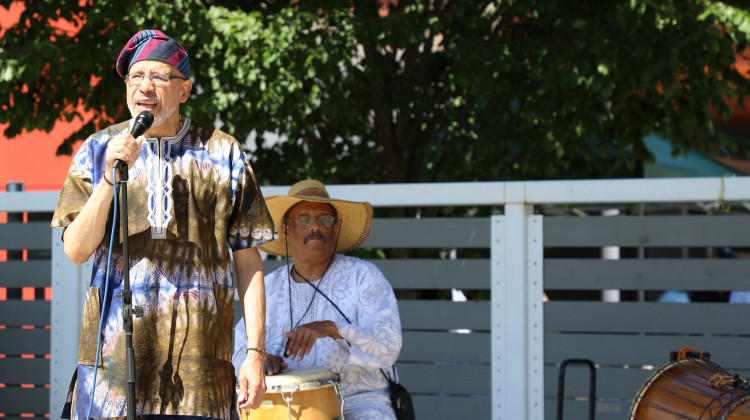 Amoah Artis leads the emancipation libation opening ceremony at the Juneteenth Tarkington Park celebration on Saturday, June 18, 2022. Artis and conga player Komoyaka King perform under the name Two Babas. - Eric Weddle / WFYI News