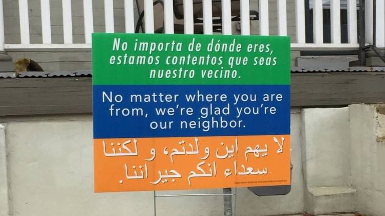 A sign in Washington, D.C., says "No matter where you're from, we're glad you're our neighbor," in three languages. It's a message that began at a church in Harrisonburg, Va., and is spreading to communities across the country.