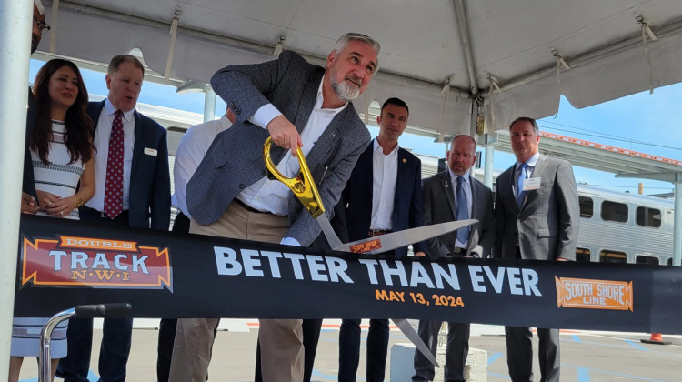 Governor Eric Holcomb cuts the ribbon on the South Shore Line's Double Track project at the railroad's Miller station on May 13. - Michael Gallenberger / Lakeshore Public Media