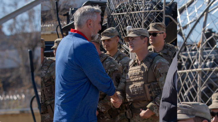 Indiana Gov. Eric Holcomb shakes a Texas National Guard member’s hand. He stood in a Feb. 4, 2024 border-centric news conference in Eagle Pass, Texas, with several other Republican governors. (Courtesy Governor’s Office)