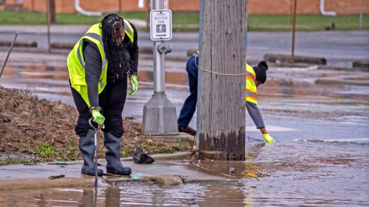 Investigators clear drains as they check on a water main break March 27, 2025, at the intersection of 22nd Street and Dr. Andrew J. Brown Avenue on the east side of Indianapolis. - Kelly Wilkinson / IndyStar via Imagn Images