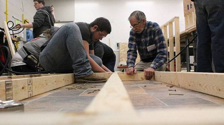 Ivy Tech students Riley Sullivan, left, and Arnold Dorey assemble part of an exterior wall during a class building simulation. - Rachel Morello/StateImpact Indiana