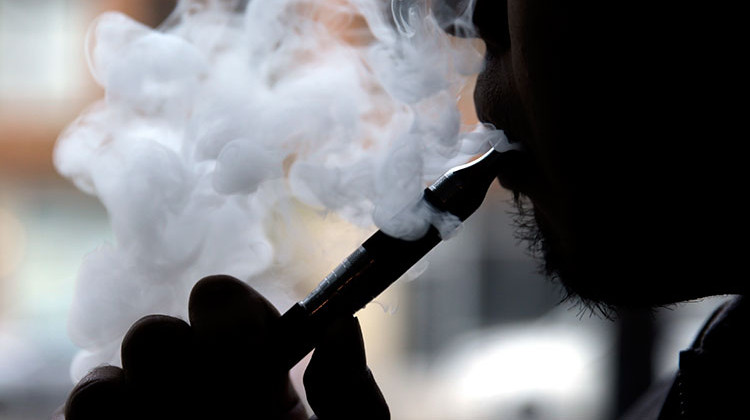 FILE - In this April 23, 2014 file photo, a man smokes an electronic cigarette in Chicago. - AP Photo/Nam Y. Huh, File