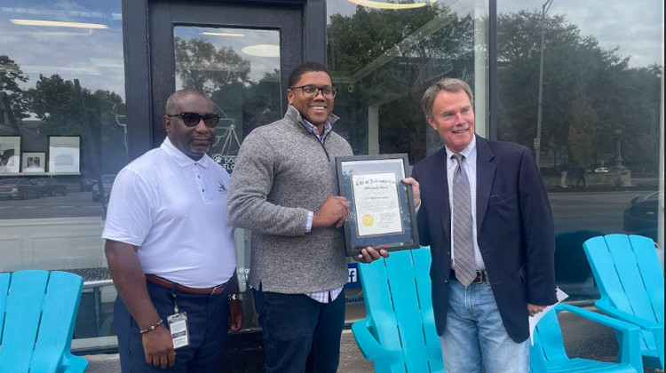 Indianapolis Mayor Joe Hogsett awards the Vendor of the Month Certificate to Ryan Lynch, the owner of Liftoff Creamery. - Sydney Dauphinais/WFYI